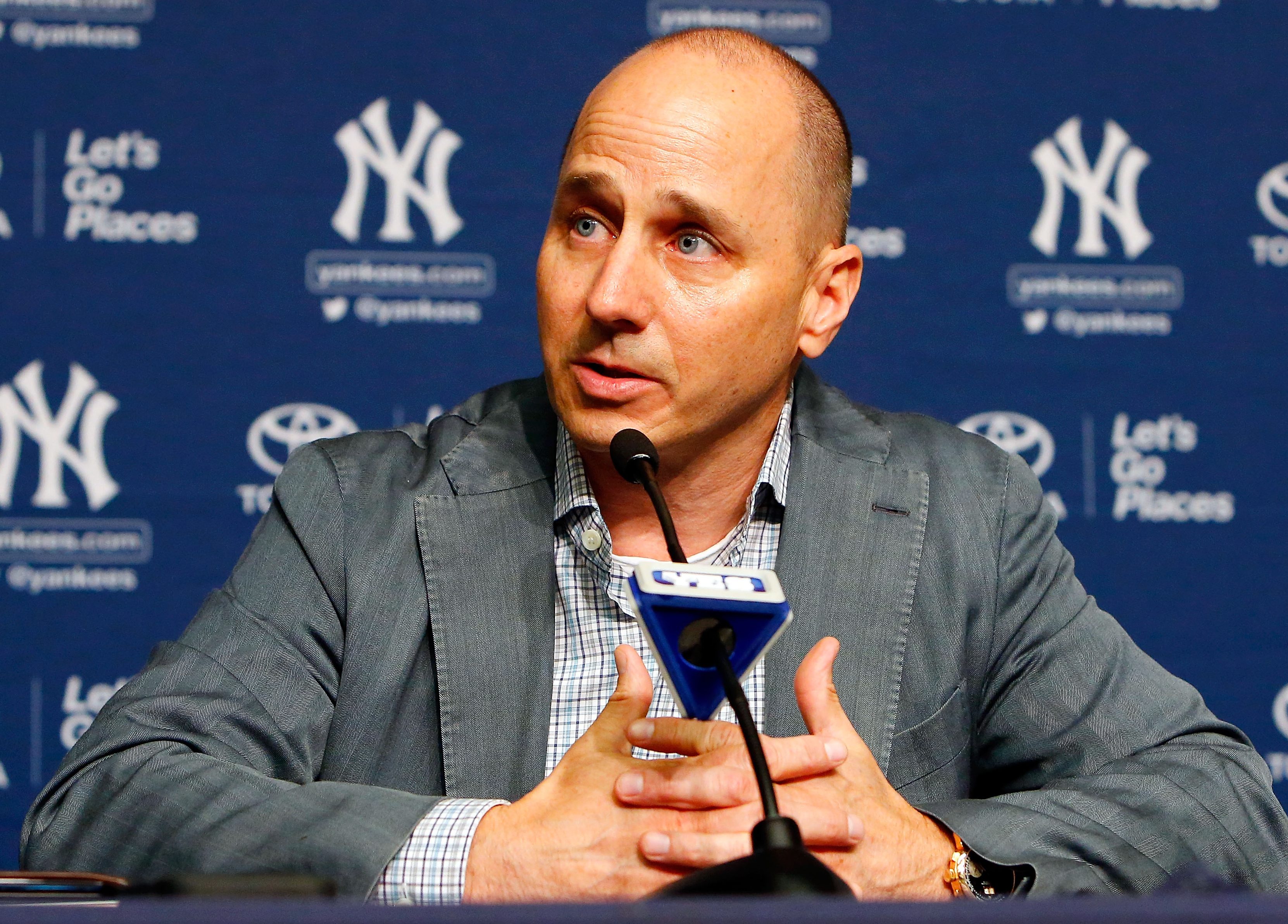 New York Yankees general manager Brian Cashman speaks during a news conference on August 7, 2016 at Yankee Stadium in the Bronx borough of New York City. (Photo by Jim McIsaac/Getty Images)