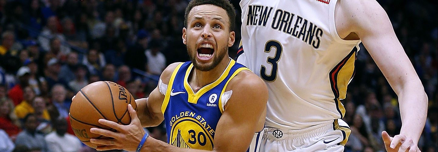 Stephen Curry #30 of the Golden State Warriors drives against Omer Asik #3 of the New Orleans Pelicans. (Photo by Jonathan Bachman/Getty Images)
