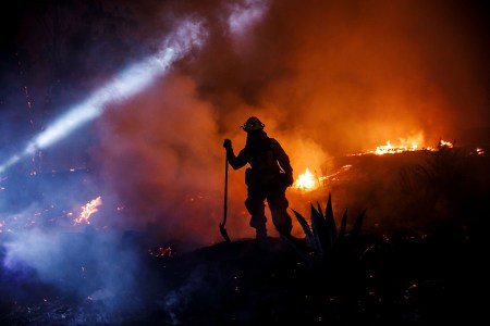 Firefighters work to control the western side of Grant Park as brushfire engulf most of the vegetation on the hill, on December 5, 2017 in Ventura, California. (Photo by Marcus Yam / Los Angeles Times via Getty Images)