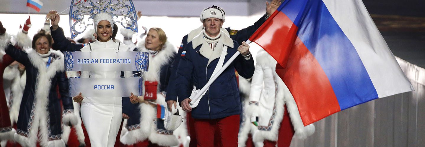 Alexander Zubkov of Russia carries the national flag as he leads the team during the opening ceremony of the 2014 Winter Olympics in Sochi, Russia. (AP Photo/Mark Humphrey, file)