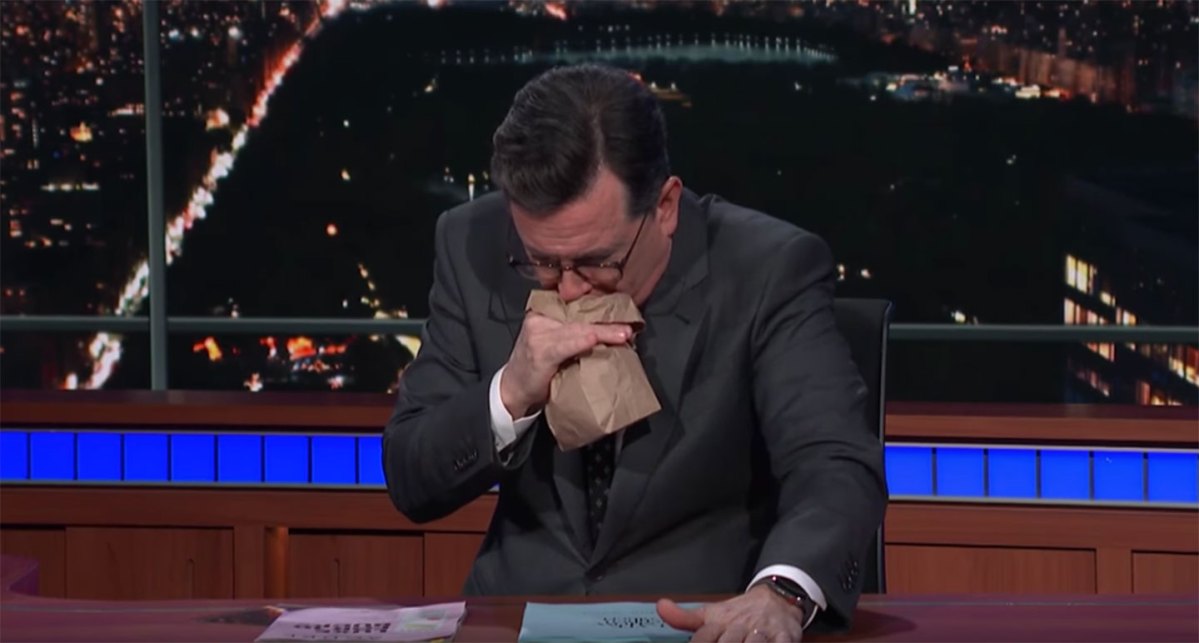 Comedian Stephen Colbert mimics vomiting into a bag after reading details from Stormy Daniels' allegations of an affair with Donald Trump. (YouTube)