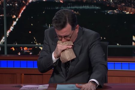 Comedian Stephen Colbert mimics vomiting into a bag after reading details from Stormy Daniels' allegations of an affair with Donald Trump. (YouTube)