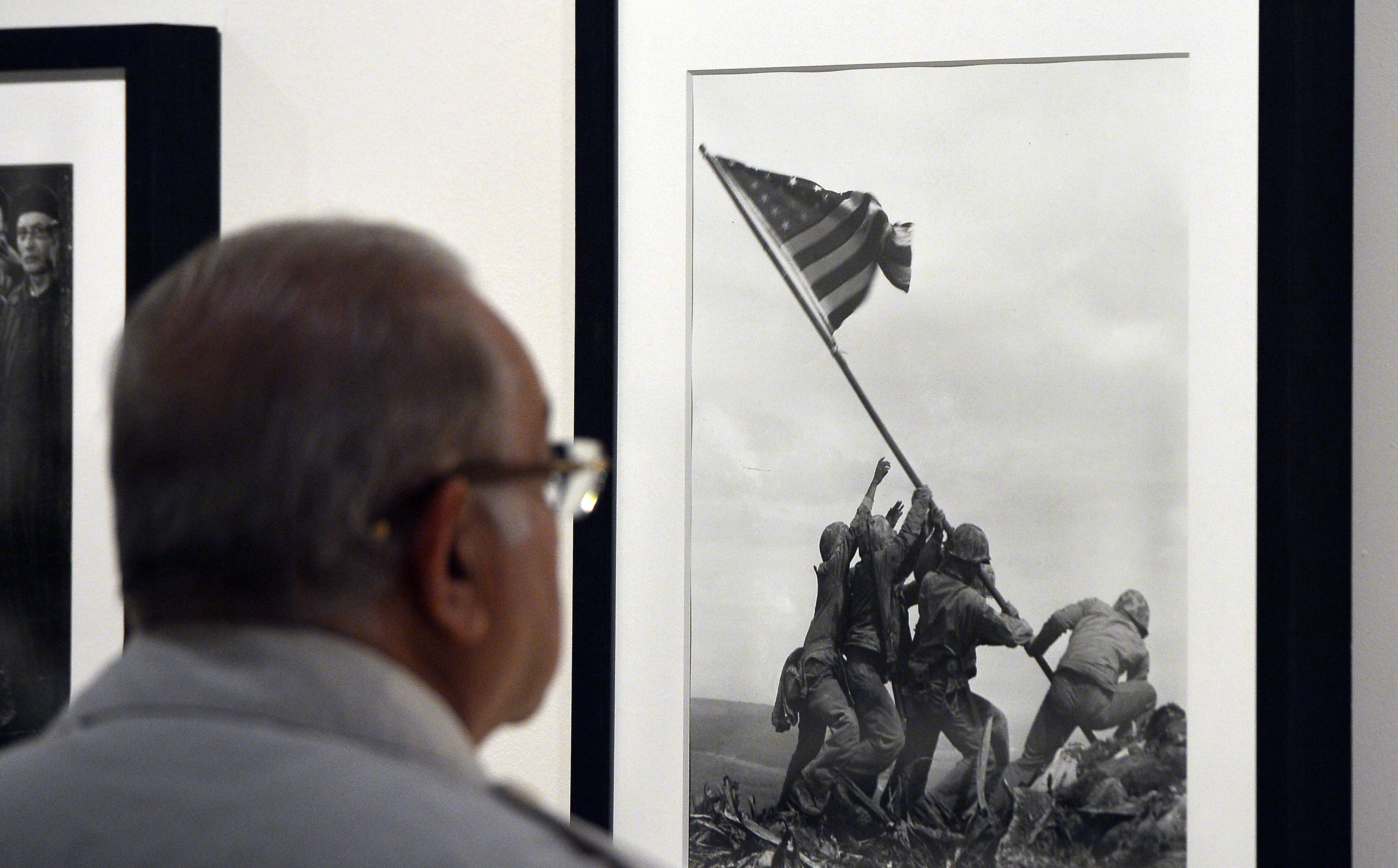A visitor looks at Joe Rosenthal's "Raising the Flag on Iwo Jima" 1945 during the 'Life. I grandi fotografi" (Life. The great photographers) exhibition at the auditorium on April 30, 2013 in Rome. (GABRIEL BOUYS/AFP/Getty Images)