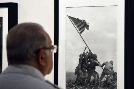 A visitor looks at Joe Rosenthal's "Raising the Flag on Iwo Jima" 1945 during the 'Life. I grandi fotografi" (Life. The great photographers) exhibition at the auditorium on April 30, 2013 in Rome. (GABRIEL BOUYS/AFP/Getty Images)