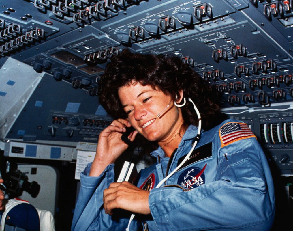 On board Scene-Astronaut Sally K. Ride, STS-7 mission specialist, communicates with ground controllers from the flight deck of the Earth-orbiting Space Shuttle Challenger. Dr. Ride holds a tape recorder. The photograph was taken by one of her four fellow crewmembers with a 35mm camera.