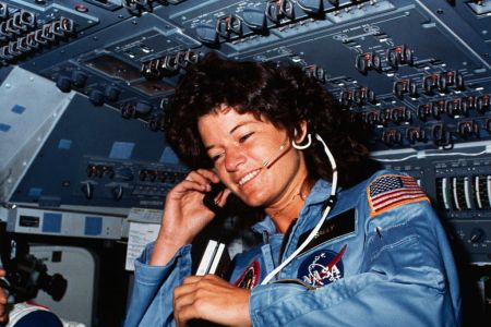 On board Scene-Astronaut Sally K. Ride, STS-7 mission specialist, communicates with ground controllers from the flight deck of the Earth-orbiting Space Shuttle Challenger. Dr. Ride holds a tape recorder. The photograph was taken by one of her four fellow crewmembers with a 35mm camera.