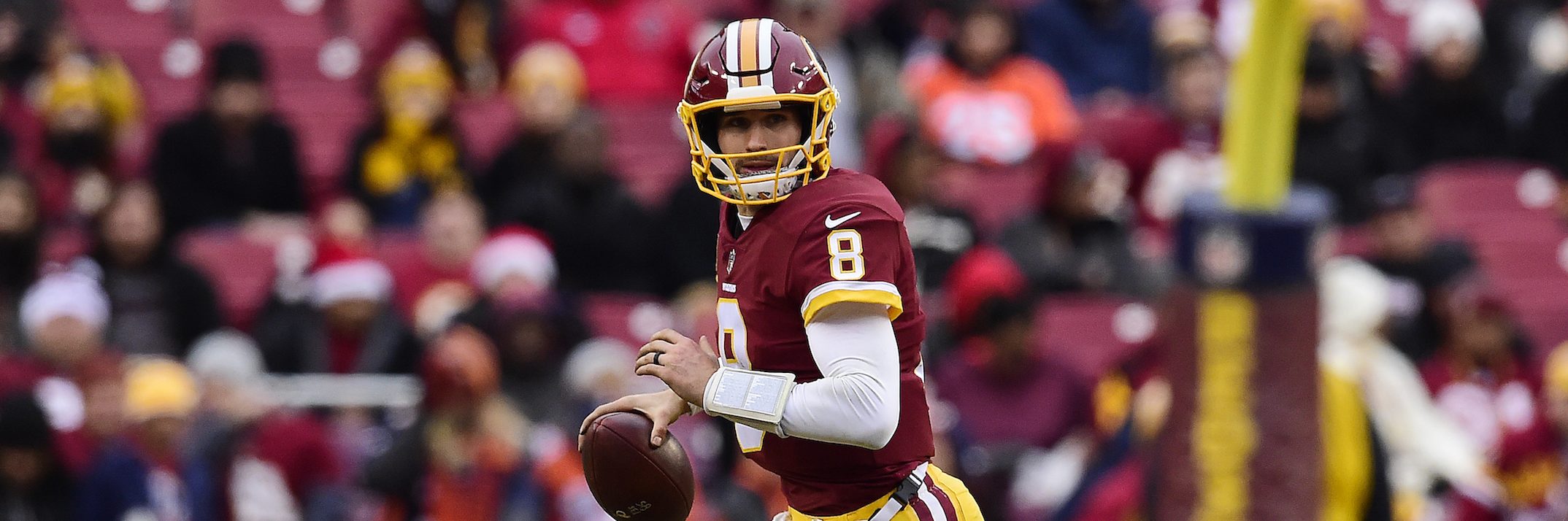 Quarterback Kirk Cousins #8 of the Washington Redskins scrambles with the ball in the fourth quarter against the Denver Broncos at FedExField on December 24, 2017 in Landover, Maryland. (Photo by Patrick McDermott/Getty Images)