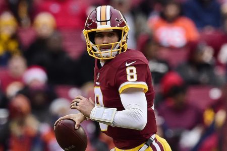 Quarterback Kirk Cousins #8 of the Washington Redskins scrambles with the ball in the fourth quarter against the Denver Broncos at FedExField on December 24, 2017 in Landover, Maryland. (Photo by Patrick McDermott/Getty Images)