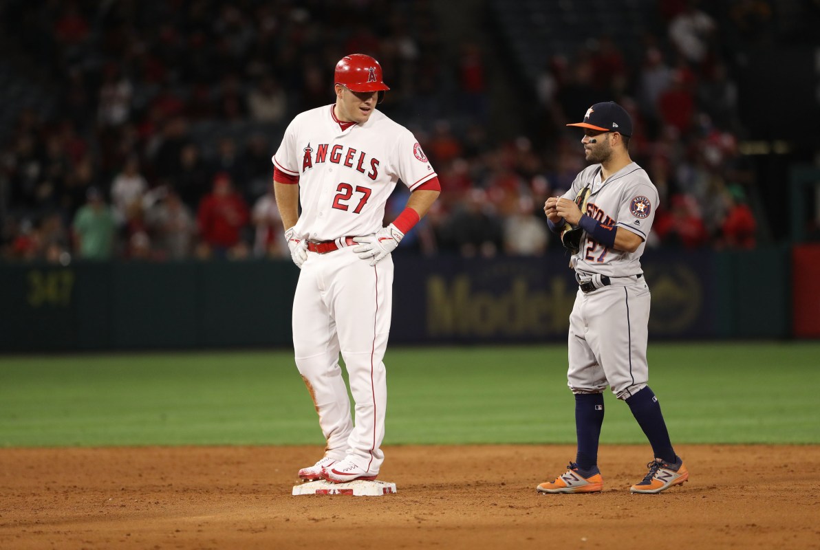 Mike Trout #27 of the Los Angeles Angels of Anaheim talks to Jose Altuve #27 of the Houston Astros during the ninth inning of their MLB game at Angel Stadium of Anaheim on May 5, 2017 in Anaheim, California. The Astros defeated the Angels 7-6 in the tenth inning.  (Photo by Victor Decolongon/Getty Images)
