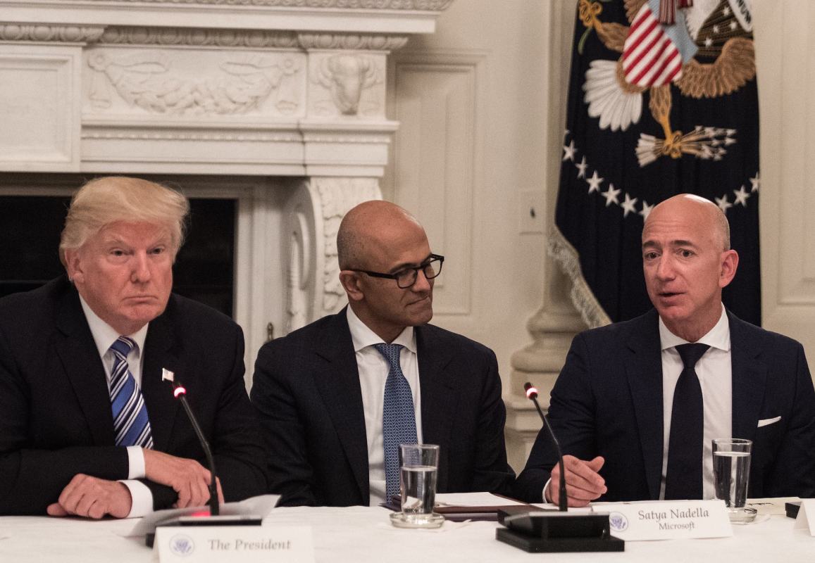 US President Donald Trump (L) and Microsoft CEO Satya Nadella (C) listen to Amazon CEO Jeff Bezos (R) during an American Technology Council roundtable at the White House in Washington, DC, on June 19, 2017.   (NICHOLAS KAMM/AFP/Getty Images)