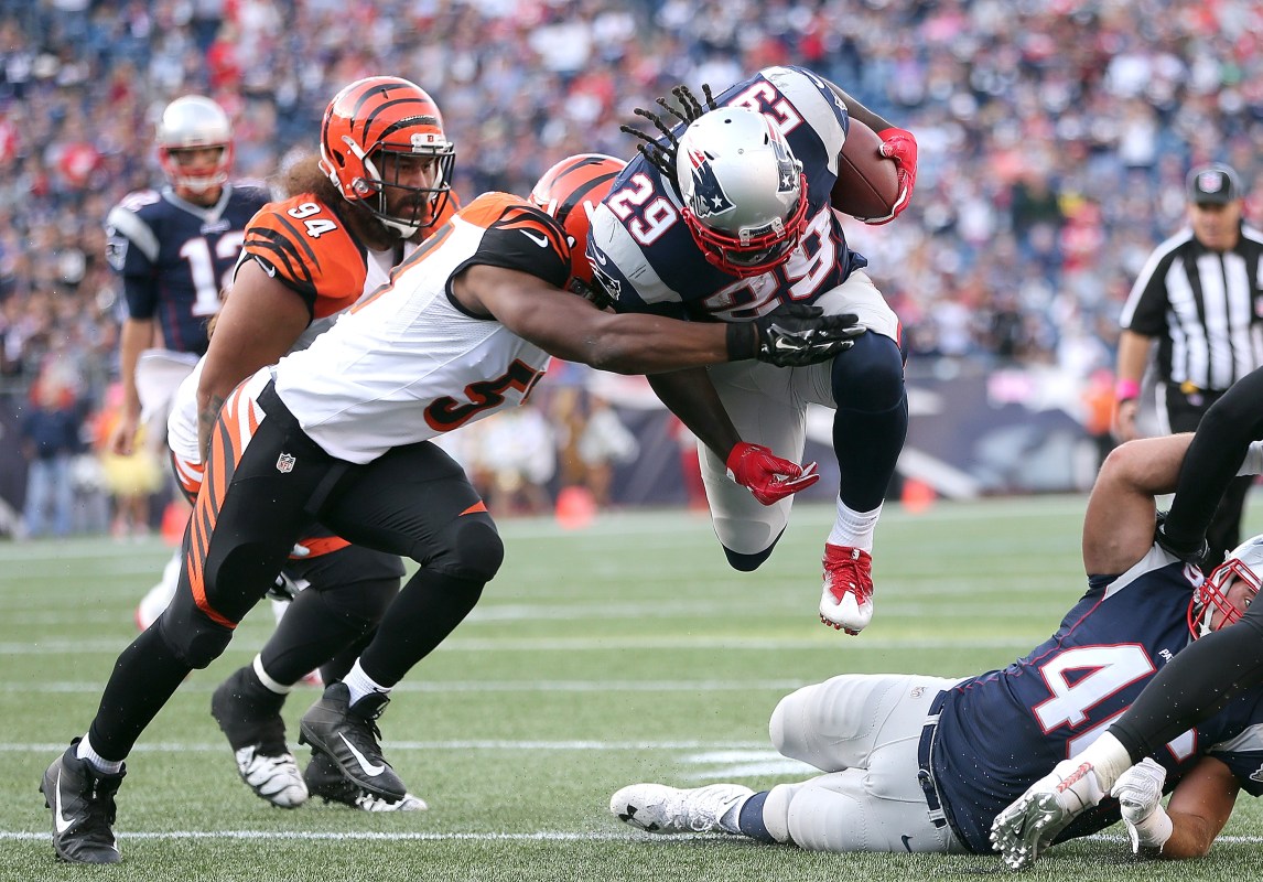 LeGarrette Blount #29 of the New England Patriots gains yards as Vontaze Burfict #55 of the Cincinnati Bengals defends in the fourth quarter at Gillette Stadium. (Photo by Jim Rogash/Getty Images)