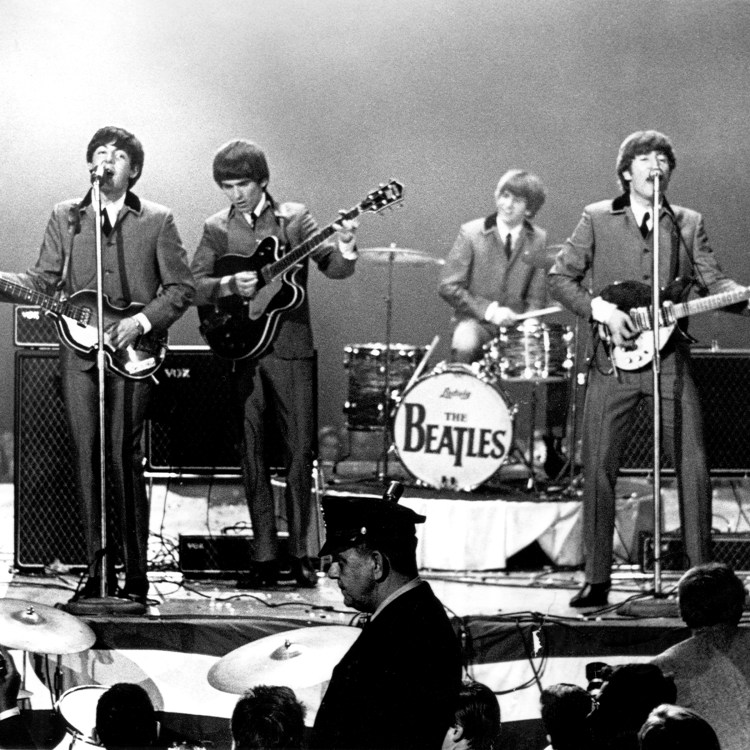 The Beatles perform onstage at the Washington Coliseum on February 11, 1964 in Washington, D.C.   (Photo by Michael Ochs Archives/Getty Images)