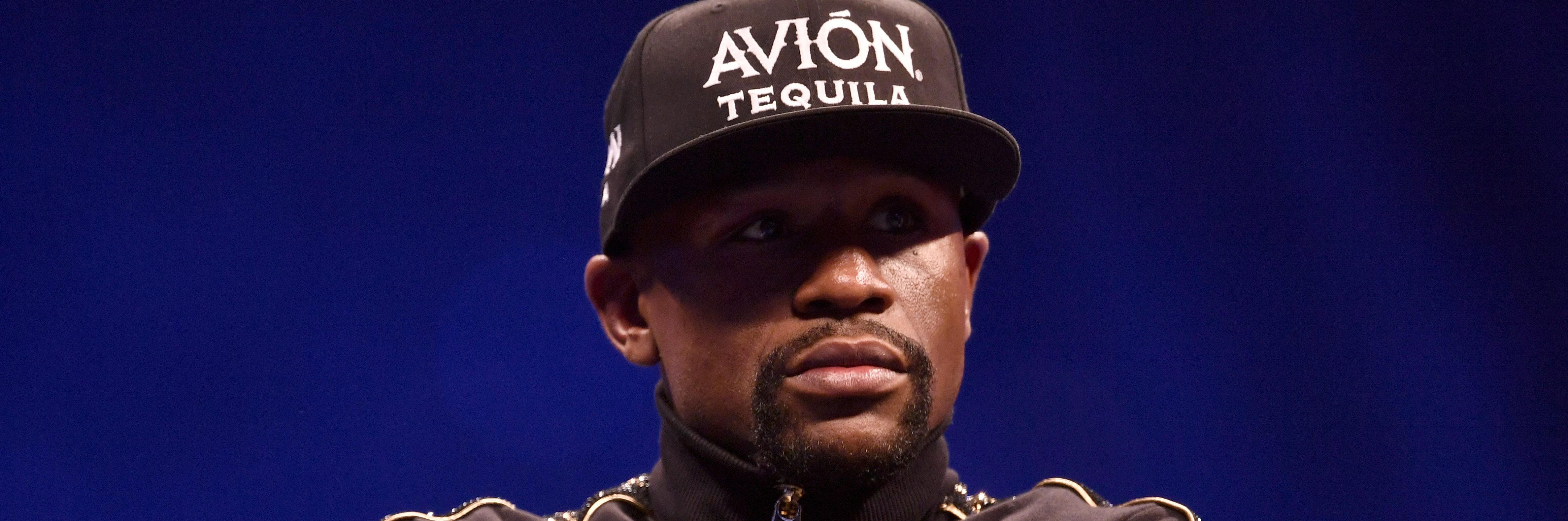 Floyd Mayweather Jr. sits onstage during a news conference. (Photo by Jeff Bottari/Zuffa LLC/Zuffa LLC via Getty Images)