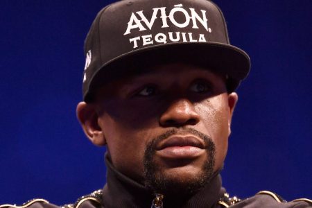 Floyd Mayweather Jr. sits onstage during a news conference.  (Photo by Jeff Bottari/Zuffa LLC/Zuffa LLC via Getty Images)