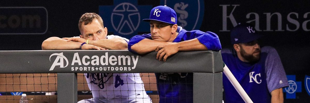 Alex Gordon #4 and Jason Vargas #51 of the Kansas City Royals sit in dejection in the dugout during ninth inning against the Chicago White Sox at Kauffman Stadium. (Photo by Brian Davidson/Getty Images)