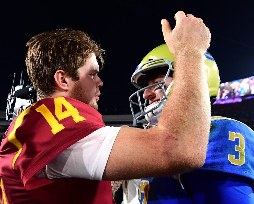 Josh Rosen #3 of the UCLA Bruins and Sam Darnold #14 of the USC Trojans meet on the field after a 28-23 Trojan win at Los Angeles Memorial Coliseum on November 18, 2017 in Los Angeles, California.  (Photo by Harry How/Getty Images)