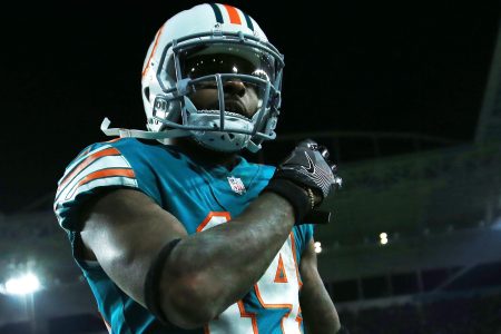 Jarvis Landry #14 of the Miami Dolphins celebrates a touchdown by teammate  Jakeem Grant #19 in the third quarter against the New England Patriots at Hard Rock Stadium on December 11, 2017.  (Photo by Chris Trotman/Getty Images)