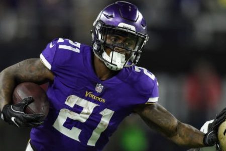 Jerick McKinnon #21 of the Minnesota Vikings carries the ball and stiff arms defender P.J. Williams #26 of the New Orleans Saints. (Photo by Hannah Foslien/Getty Images)