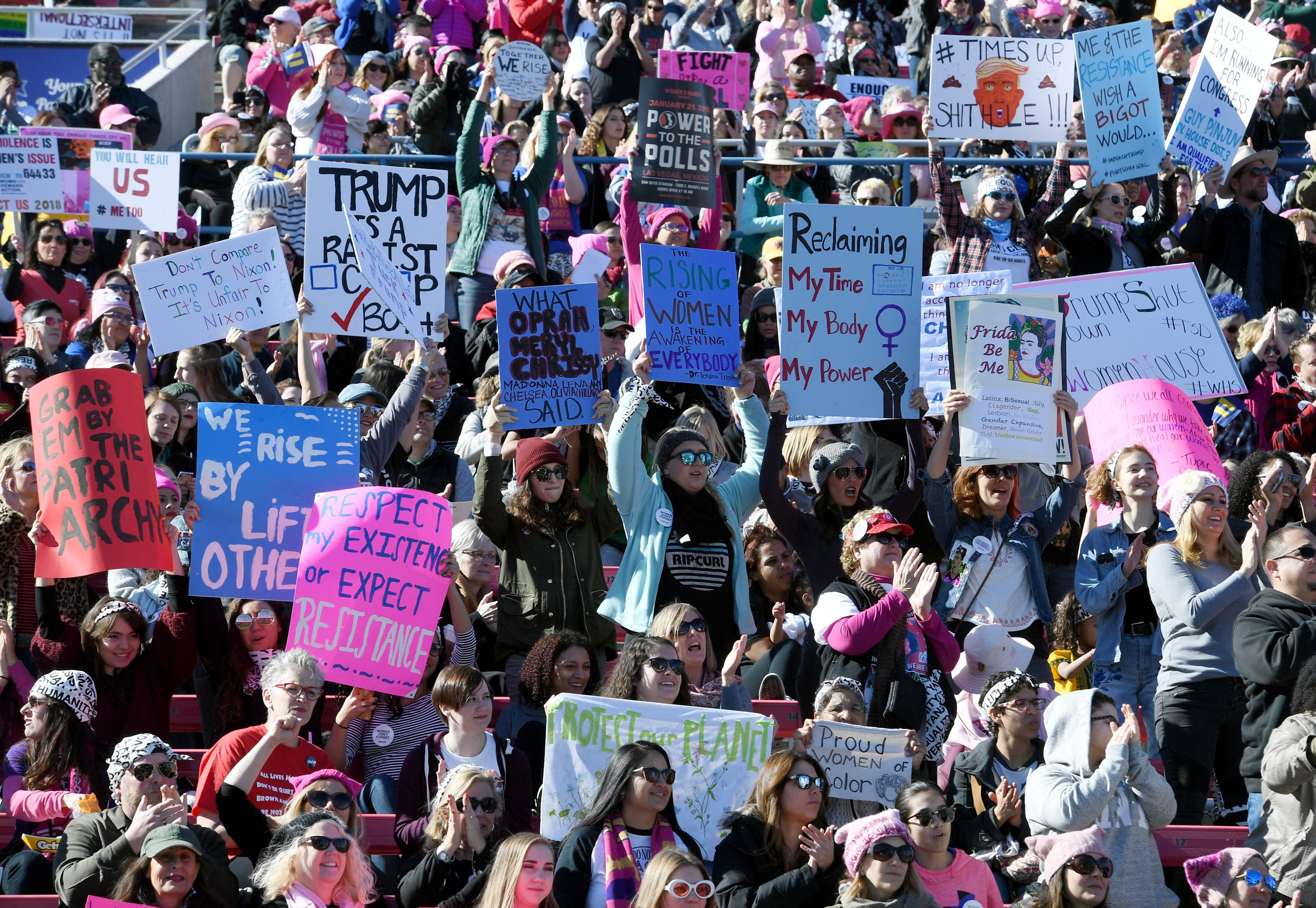 Attendees hold signs during the Women's March "Power to the Polls" voter registration tour launch at Sam Boyd Stadium on January 21, 2018 in Las Vegas, Nevada. Demonstrators across the nation gathered over the weekend, one year after the historic Women's March on Washington, D.C., to protest President Donald Trump's administration and to raise awareness for women's issues. (Ethan Miller/Getty Images)