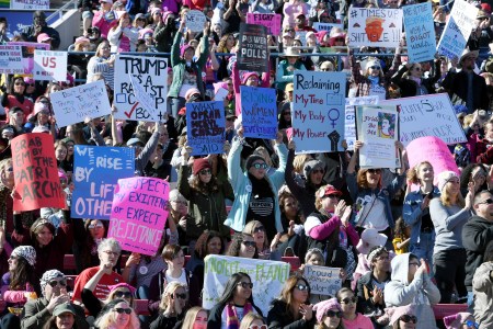 Attendees hold signs during the Women's March "Power to the Polls" voter registration tour launch at Sam Boyd Stadium on January 21, 2018 in Las Vegas, Nevada. Demonstrators across the nation gathered over the weekend, one year after the historic Women's March on Washington, D.C., to protest President Donald Trump's administration and to raise awareness for women's issues.  (Ethan Miller/Getty Images)