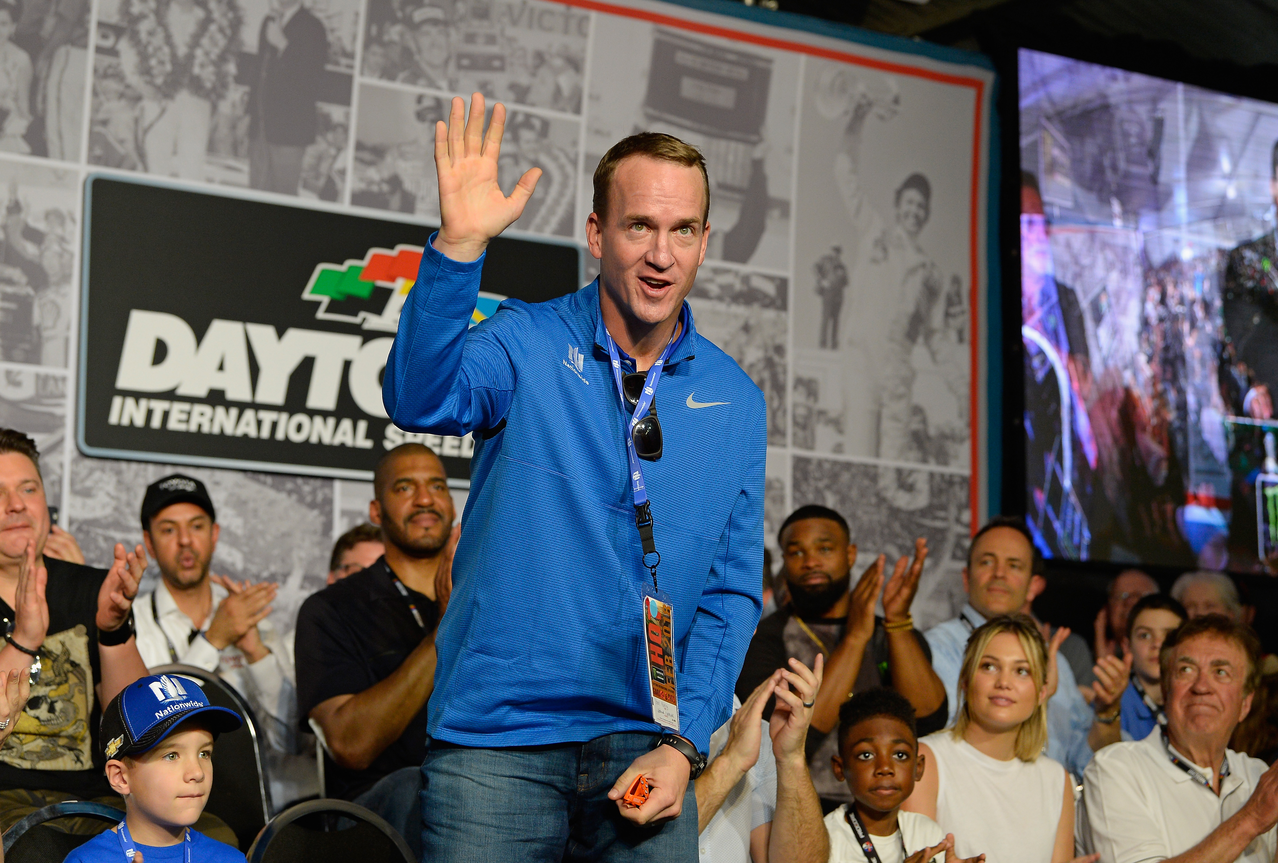 Peyton Manning waves to the crowd during the drivers meeting for the Monster Energy NASCAR Cup Series 60th Annual Daytona 500 at Daytona International Speedway on February 18, 2018 in Daytona Beach, Florida.  (Photo by Robert Laberge/Getty Images)