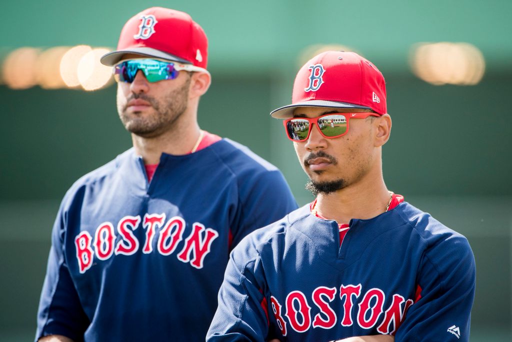 J.D. Martinez #28 and Mookie Betts #50 of the Boston Red Sox look on before a game against the Pittsburgh Pirates at JetBlue Park at Fenway South on February 28, 2018 in Fort Myers, Florida. (Photo by Billie Weiss/Boston Red Sox/Getty Images)