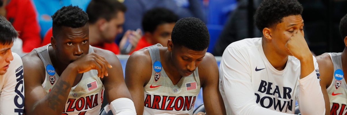 Emmanuel Akot #24 of the Arizona Wildcats (L) and Dylan Smith #3 (C) react in the second half against the Buffalo Bulls during the first round of the 2018 NCAA Men's Basketball Tournament. (Photo by Kevin C. Cox/Getty Images)