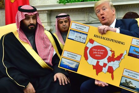 President Donald Trump (R) holds up a chart of military hardware sales as he meets with Crown Prince Mohammed bin Salman of the Kingdom of Saudi Arabia in the Oval Office at the White House on March 20, 2018 in Washington, D.C.  (Photo by Kevin Dietsch-Pool/Getty Images)
