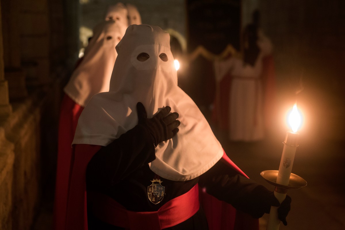 The brothers of the brotherhood of Santo Entierro go with candles during the procession of Holy Mercy, it goes through the cloister of the Santander cathedral during the night of Holy Wednesday. (Joaquin Gomez Sastre/NurPhoto via Getty Images)