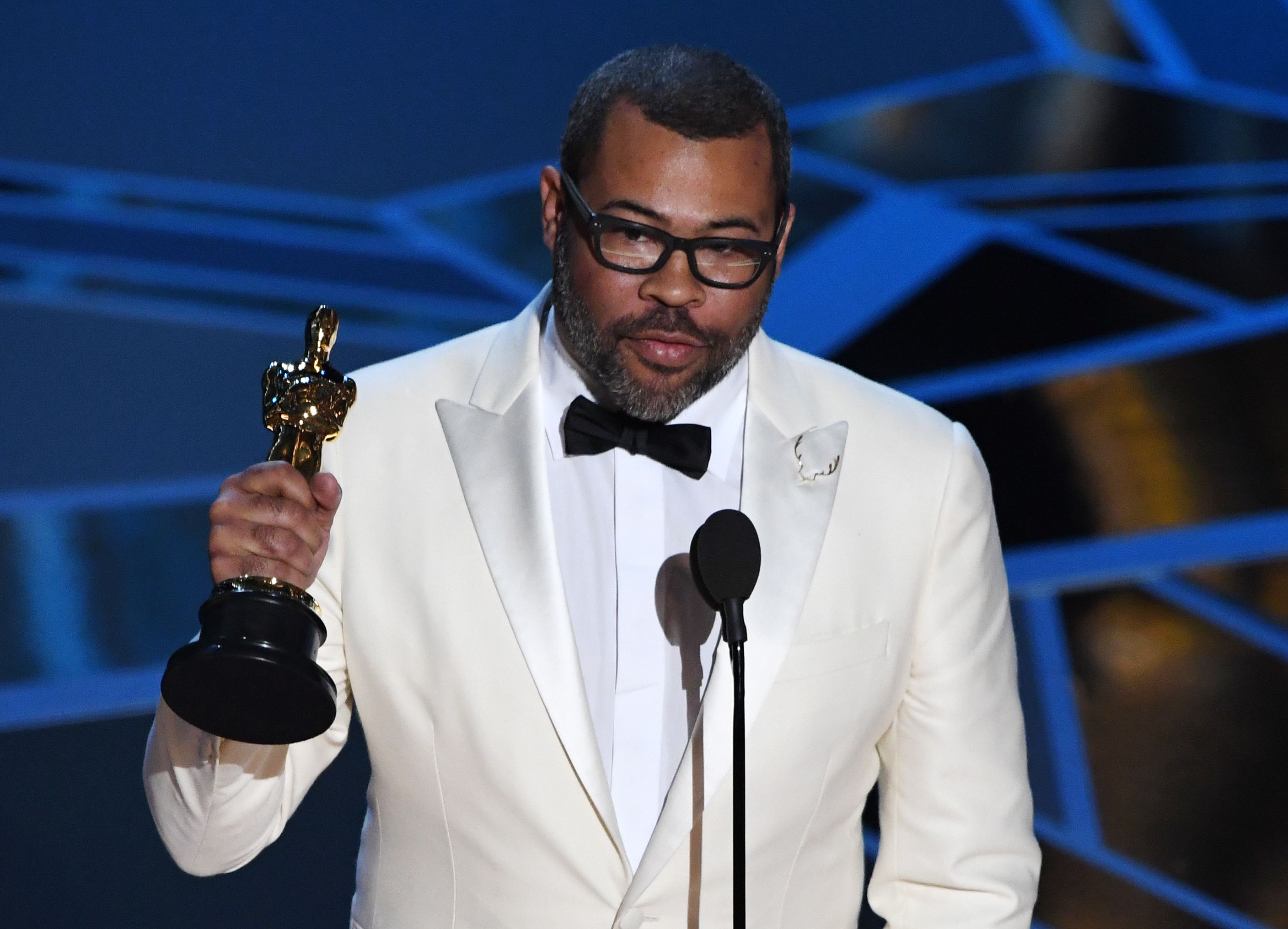 TOPSHOT - Director Jordan Peele delivers a speech after he won the Oscar for Best Original Screenplay for "Get Out" during the 90th Annual Academy Awards show on March 4, 2018 in Hollywood, California. / AFP PHOTO / Mark Ralston (Photo credit should read MARK RALSTON/AFP/Getty Images)