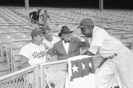 The Dodgers at Yankee Stadium are shown with left to right Gil Hodges, Gene Hermanski, Branch Rickey, and Jackie Robinson, during the World Series.