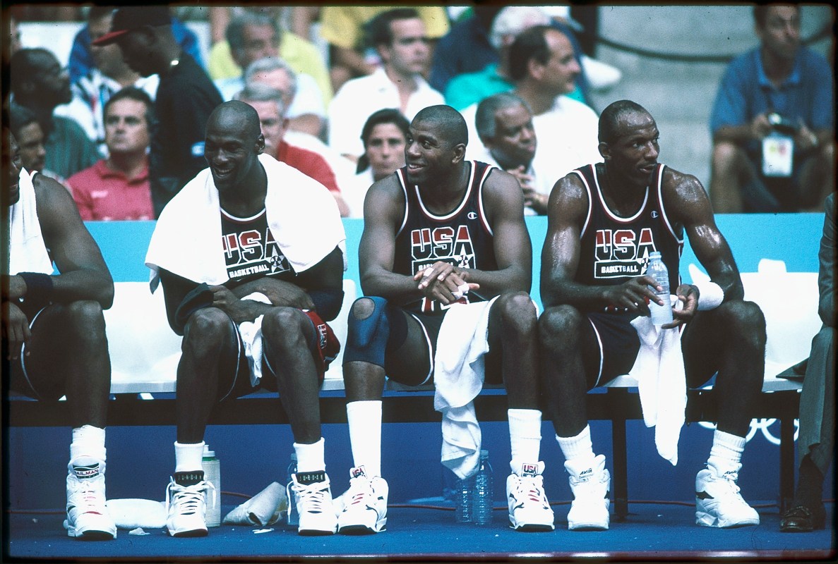 1992:  Michael Jordan (L), Magic Johnson (M) and Clyde Drexler (R) of Team USA, the Dream Team, sit on the bench during the men's basketball competition at the 1992 Summer Olympics in Barcelona, Spain. (Photo by Icon Sportswire)