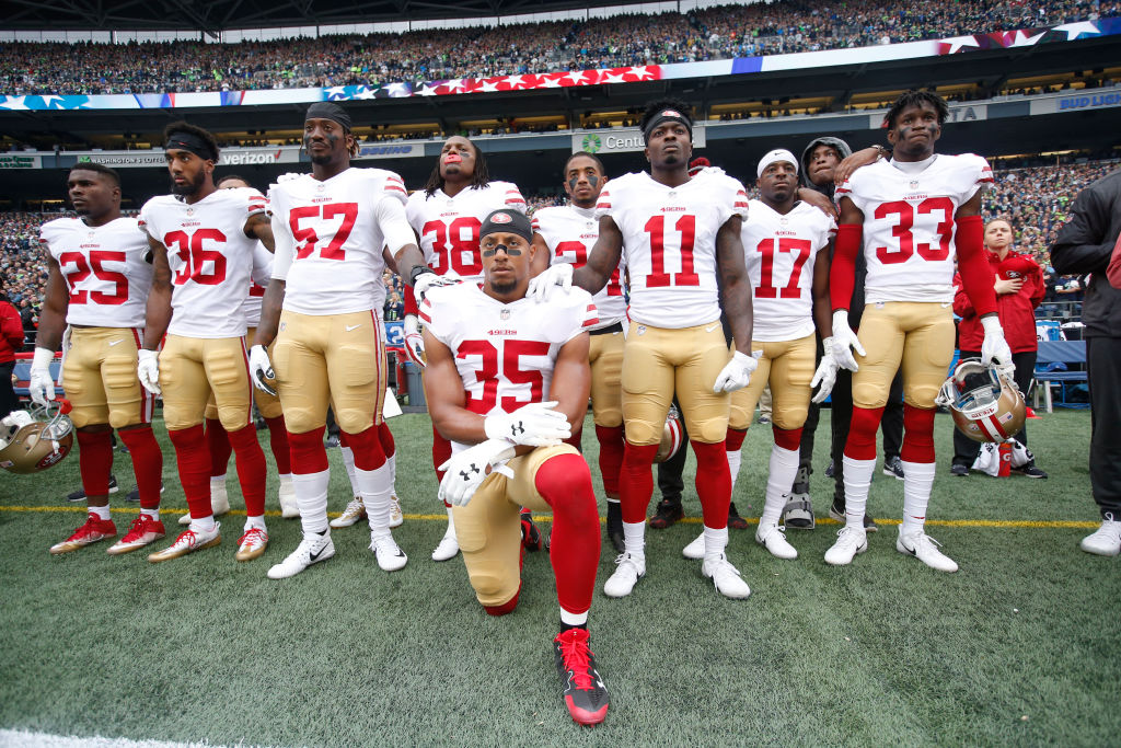 Eric Reid #35 of the San Francisco 49ers kneels during the anthem with the support of teammates prior to the game against the Seattle Seahawks at CenturyLink Field on September 17, 2017 in Seattle, Washington. (Photo by Michael Zagaris/San Francisco 49ers/Getty Images)
