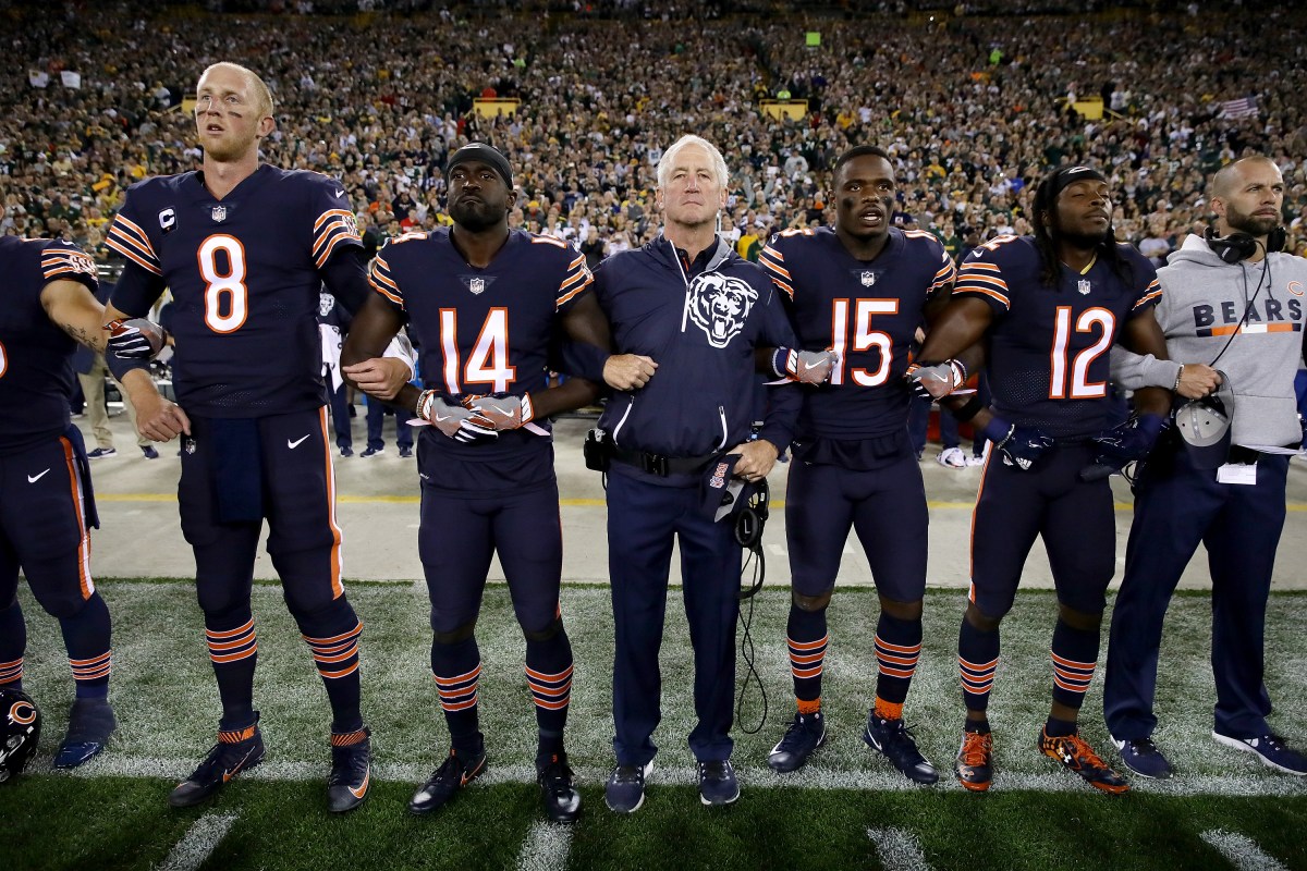 Head coach John Fox of the Chicago Bears links arms with players during the singing of the national anthem before the game against the Green Bay Packers at Lambeau Field on September 28, 2017 in Green Bay, Wisconsin. (Jonathan Daniel/Getty Images)