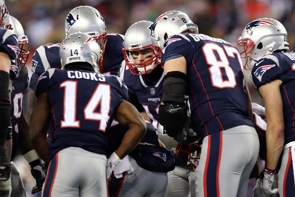 Tom Brady #12 of the New England Patriots reacts in the huddle with Brandin Cooks #14 and Rob Gronkowski #87 during the fourth quarter  in the AFC Divisional Playoff game against the Tennessee Titans at Gillette Stadium on January 13, 2018 in Foxborough, Massachusetts.  (Photo by Elsa/Getty Images)