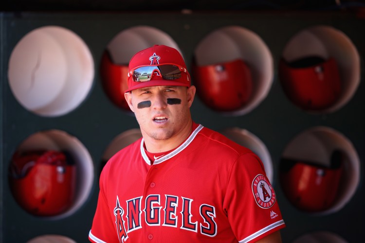 Mike Trout #27 of the Los Angeles Angels stands in the dugout before their game against the Oakland Athletics at Oakland Alameda Coliseum on March 29, 2018 in Oakland, California.  (Photo by Ezra Shaw/Getty Images)