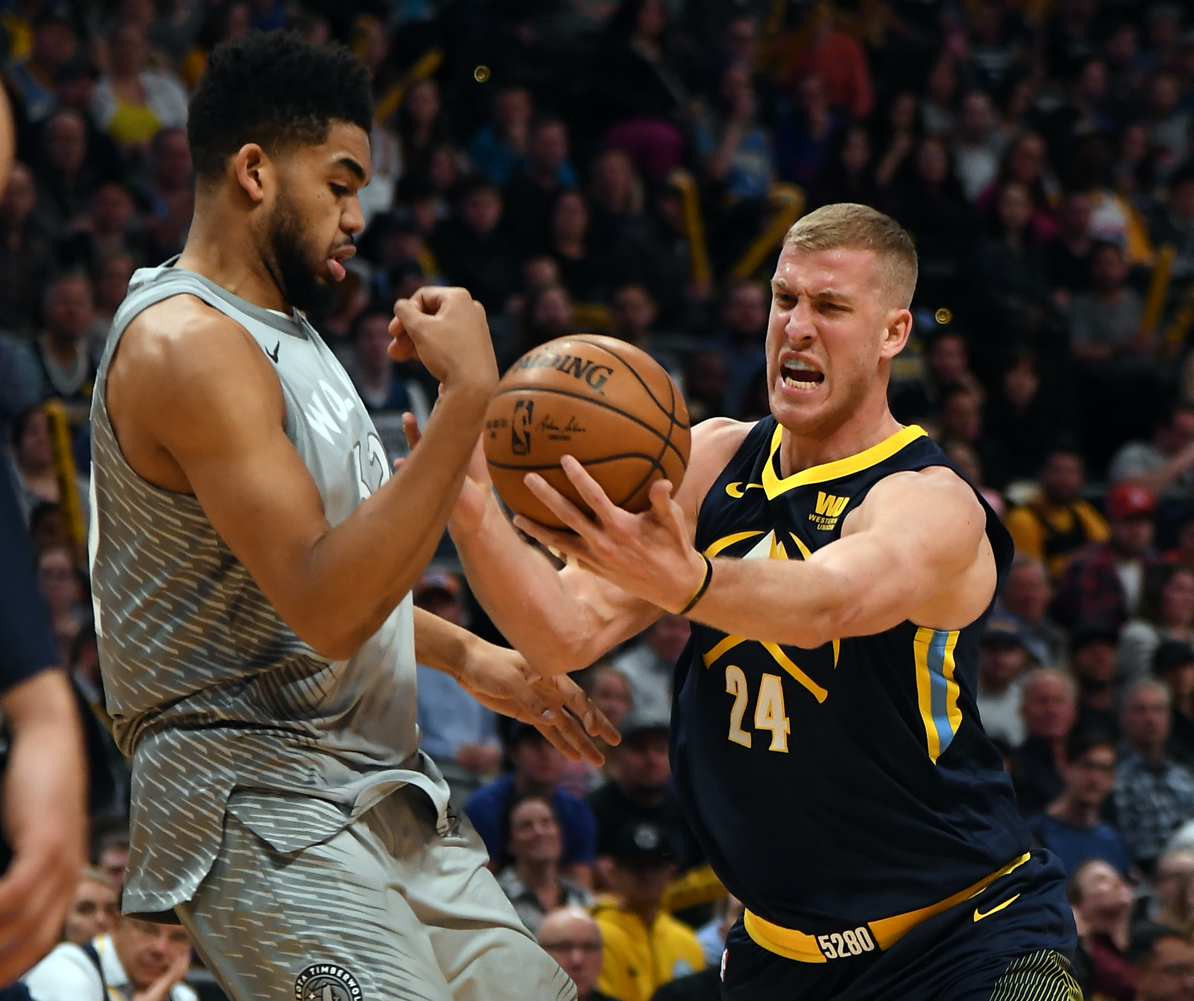 Denver Nuggets center Mason Plumlee (24) just about loses control of the ball as Minnesota Timberwolves center Karl-Anthony Towns (32) swipes at it during the second quarter on April 5, 2018 at Pepsi Center. (Photo by John Leyba/The Denver Post via Getty Images)