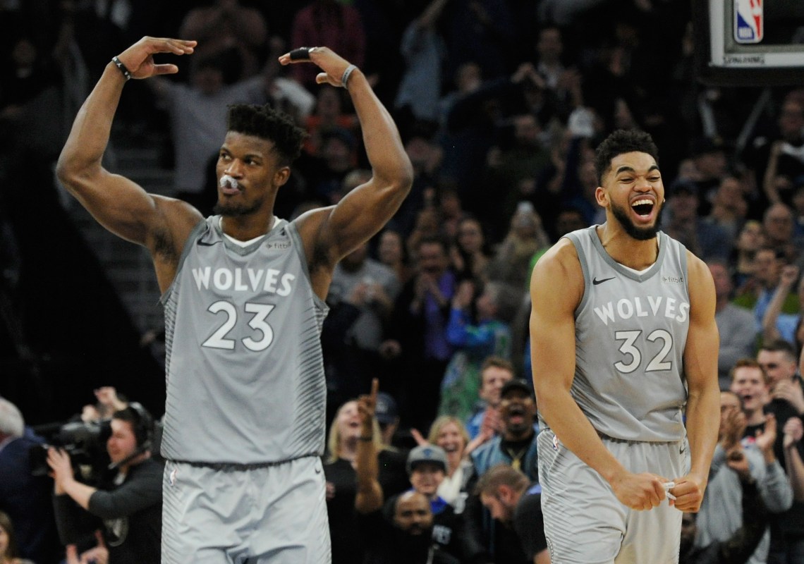 Jimmy Butler #23 and Karl-Anthony Towns #32 of the Minnesota Timberwolves celebrate in the final minute of overtime of the game against the Denver Nuggets on April 11, 2018 at the Target Center in Minneapolis, Minnesota. (Photo by Hannah Foslien/Getty Images)