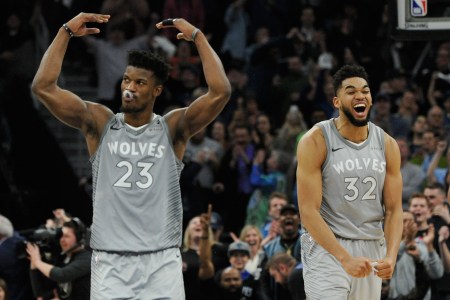 Jimmy Butler #23 and Karl-Anthony Towns #32 of the Minnesota Timberwolves celebrate in the final minute of overtime of the game against the Denver Nuggets on April 11, 2018 at the Target Center in Minneapolis, Minnesota. (Photo by Hannah Foslien/Getty Images)