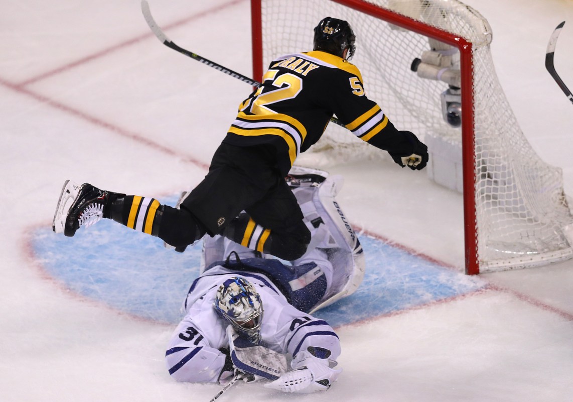 Boston Bruins Sean Kuraly falls over Toronto Maple Leafs goalie Frederik Andersen after scoring a third period goal in Game One of the Eastern Conference First Round during the 2018 NHL Stanley Cup Playoffs at TD Garden in Boston on April 12, 2018. (Photo by John Tlumacki/The Boston Globe via Getty Images)