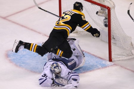Boston Bruins Sean Kuraly falls over Toronto Maple Leafs goalie Frederik Andersen after scoring a third period goal in Game One of the Eastern Conference First Round during the 2018 NHL Stanley Cup Playoffs at TD Garden in Boston on April 12, 2018. (Photo by John Tlumacki/The Boston Globe via Getty Images)