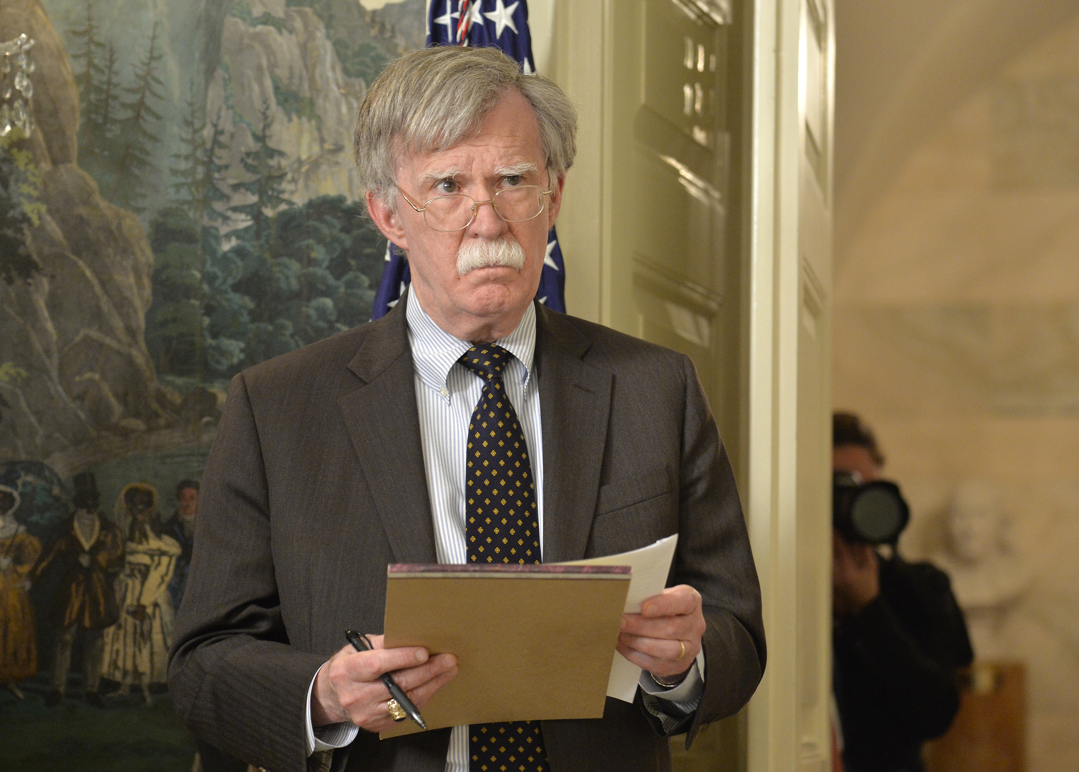 WASHINGTON, DC - APRIL 13: National Security Advisor John Bolton listens to remarks by U.S. President Donald Trump as he speaks to the nation, announcing military action against Syria for the recent apparent gas attack on its civilians, at the White House, on April 13, 2018, in Washington, DC. President Trump announced that a joint operation of "precision strikes" is underway in Syria with armed forces from the United Kingdom and France.  (Photo by Mike Theiler - Pool/Getty Images)