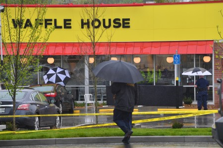Law enforcement stand outside a Waffle House where four people were killed and two were wounded after a gunman opened fire with an assault weapon on April 22, 2018 in Nashville, Tennessee. Travis Reinking, 29, of Morton, IL, is person of interest in the shooting and is suspected to have left the scene naked. (Photo by Jason Davis/Getty Images)
