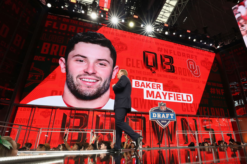 NFL Commissioner Roger Goodell walks past a video board displaying an image of Baker Mayfield of Oklahoma after he was picked #1 overall by the Cleveland Browns during the first round of the 2018 NFL Draft at AT&T Stadium on April 26, 2018 in Arlington, Texas.  (Photo by Ronald Martinez/Getty Images)