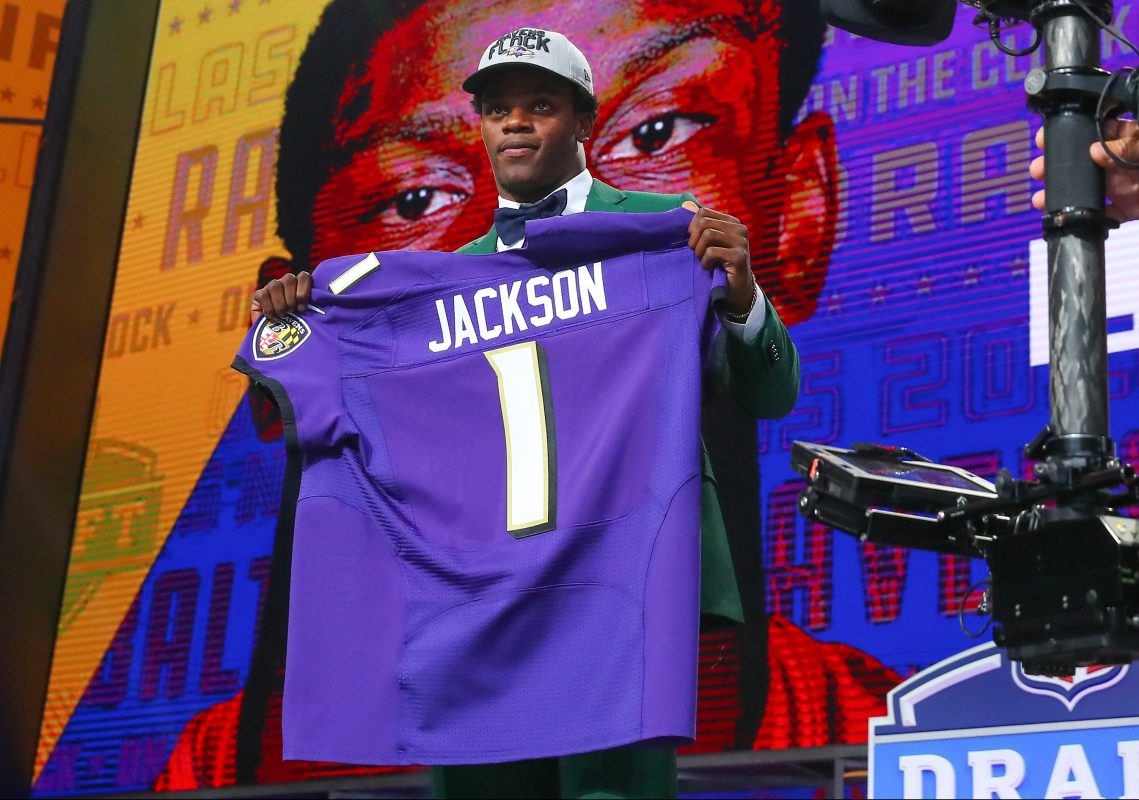 Lamar Jackson holds up a jersey after being chosen by the Baltimore Ravens with the 32nd pick during the first round at the 2018 NFL Draft at AT&T Statium on April 26, 2018 at AT&T Stadium in Arlington Texas.  (Photo by Rich Graessle/Icon Sportswire via Getty Images)