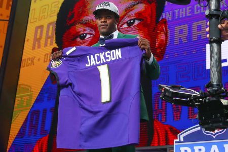 Lamar Jackson holds up a jersey after being chosen by the Baltimore Ravens with the 32nd pick during the first round at the 2018 NFL Draft at AT&T Statium on April 26, 2018 at AT&T Stadium in Arlington Texas.  (Photo by Rich Graessle/Icon Sportswire via Getty Images)
