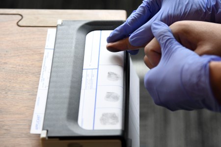 Kelsey  Kuenstler, HopSkipDrive operations associate for Denver, right with gloves, fingerprints care driver Anthony Jones during an orientation class for the new HopSkipDrive, a ride service for kids at Enterprise Coworking April 04, 2018. (Photo by Andy Cross/The Denver Post via Getty Images)