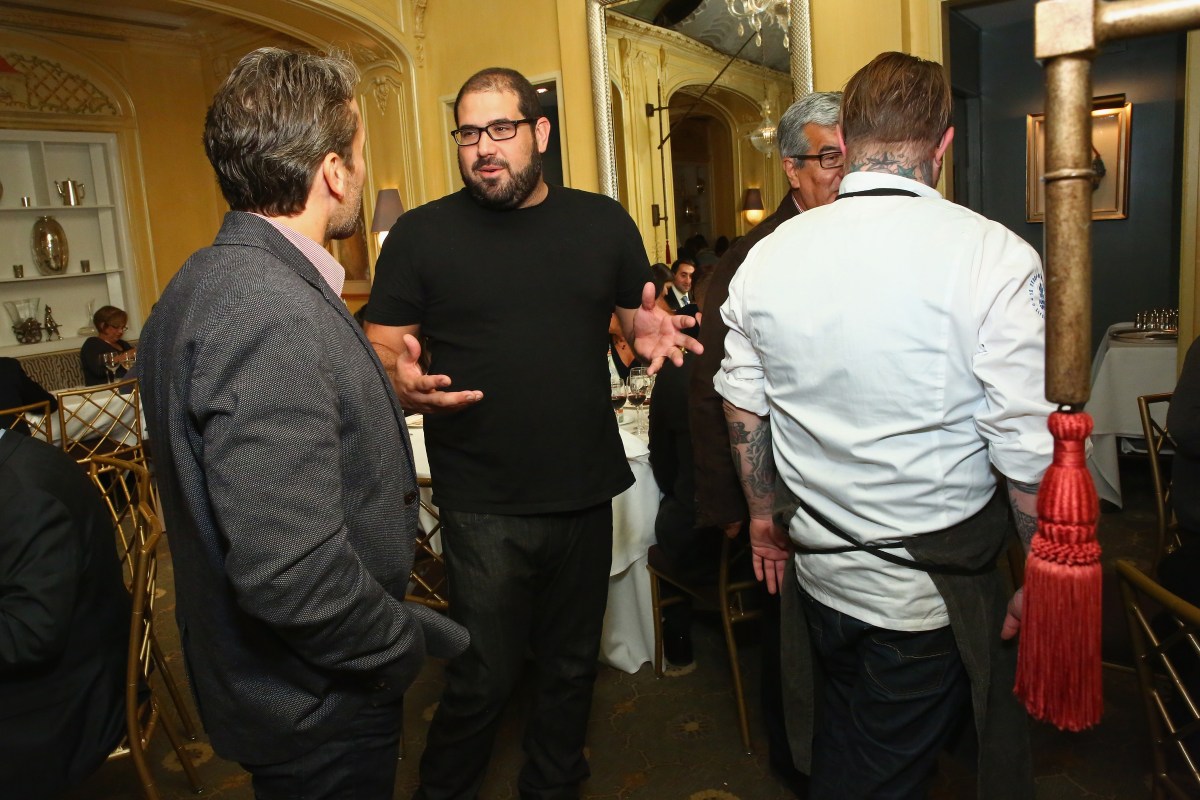 Chef Jose Enrique with guests at A Dinner With Jose Enrique And Jamie Bissonnette, part of the Bank Of America Dinner Series during Food Network & Cooking Channel New York City Wine & Food Festival presented by FOOD & WINE at Hotel Plaza Athenee on October 16, 2015 in New York City.  (Astrid Stawiarz/Getty Images for NYCWFF)