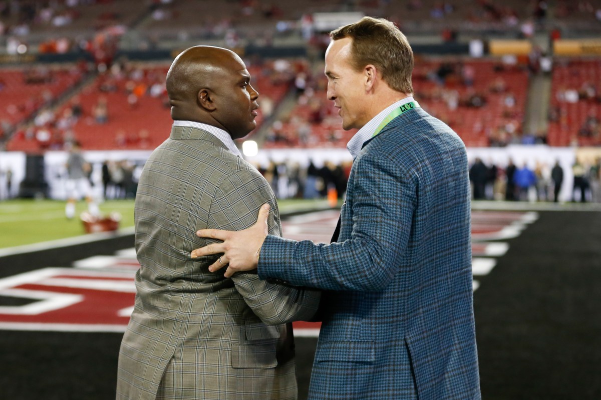 Former NFL players Anthony "Booger" McFarland and Peyton Manning talk on before  the 2017 College Football National Championship Game between the Clemson Tigers and Alabama Crimson Tide on January 9, 2017, at Raymond James Stadium in Tampa, FL. (Mark LoMoglio/Icon Sportswire via Getty Images)