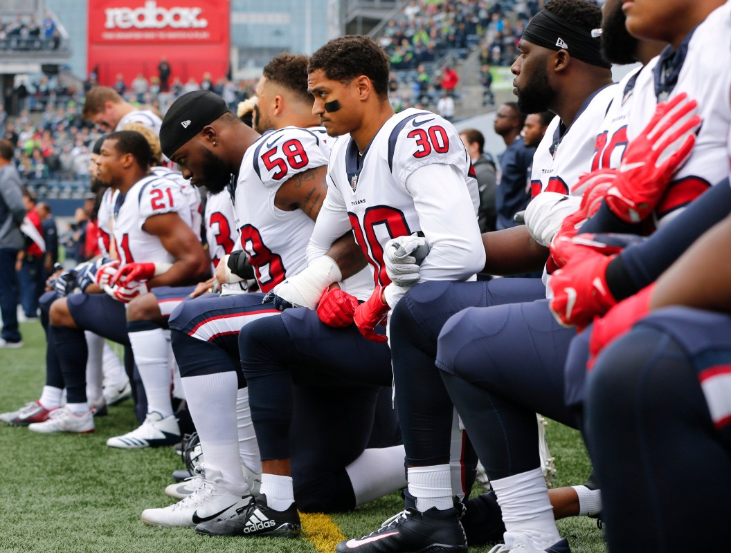 Members of the Houston Texans, including Kevin Johnson #30 and Lamarr Houston #58, kneel during the national anthem before the game at CenturyLink Field on October 29, 2017 in Seattle, Washington.  (Jonathan Ferrey/Getty Images)